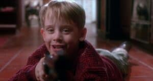 Kevin McAllister (Macaulay Culkin) with a gun in 'Home Alone'