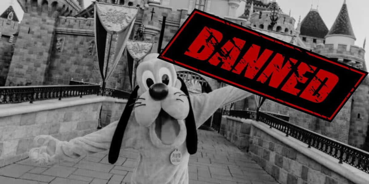 Black & white photo of Pluto in front of Sleeping Beauty Castle from Disneyland Park with text reading banned.