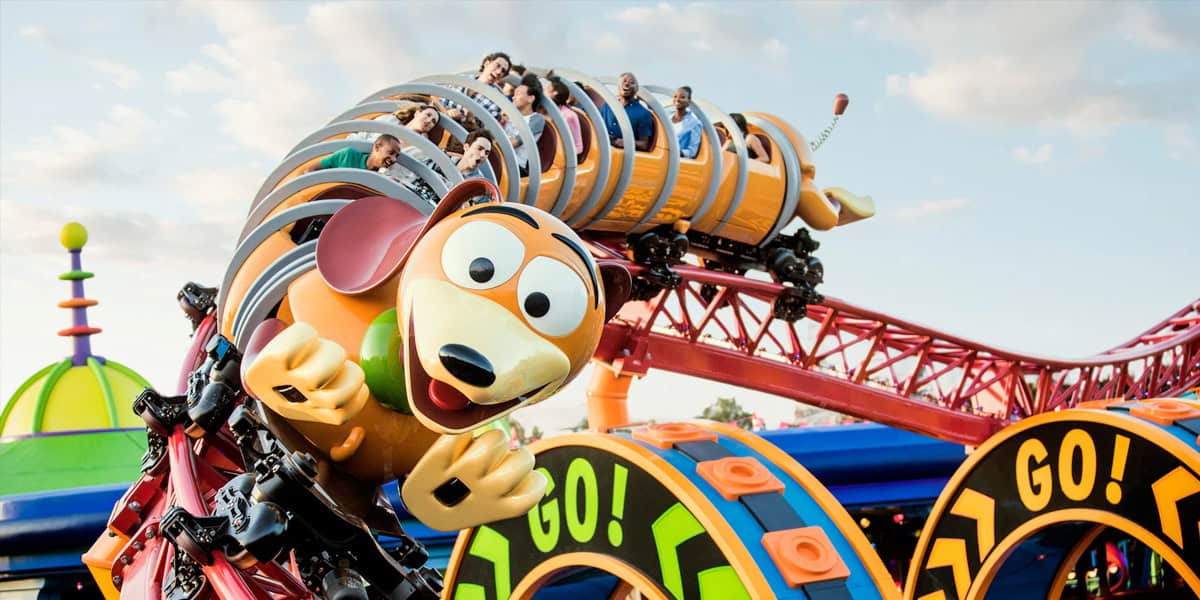 Roller coaster shaped like Slinky from Toy Story, with people riding inside the coils.
