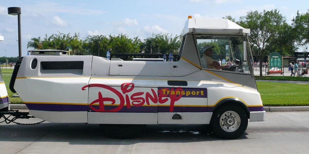 A Disney Transport tram at Walt Disney World Resort with a large "Disney" logo on the side
