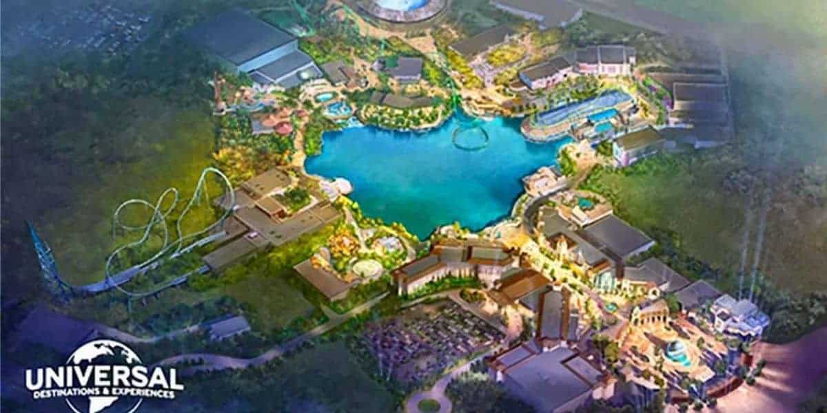 A colorful aerial illustration of a theme park with a large blue lake at the center, surrounded by rides, roller coasters, and buildings. The Universal Destinations & Experiences logo is in the bottom left corner.