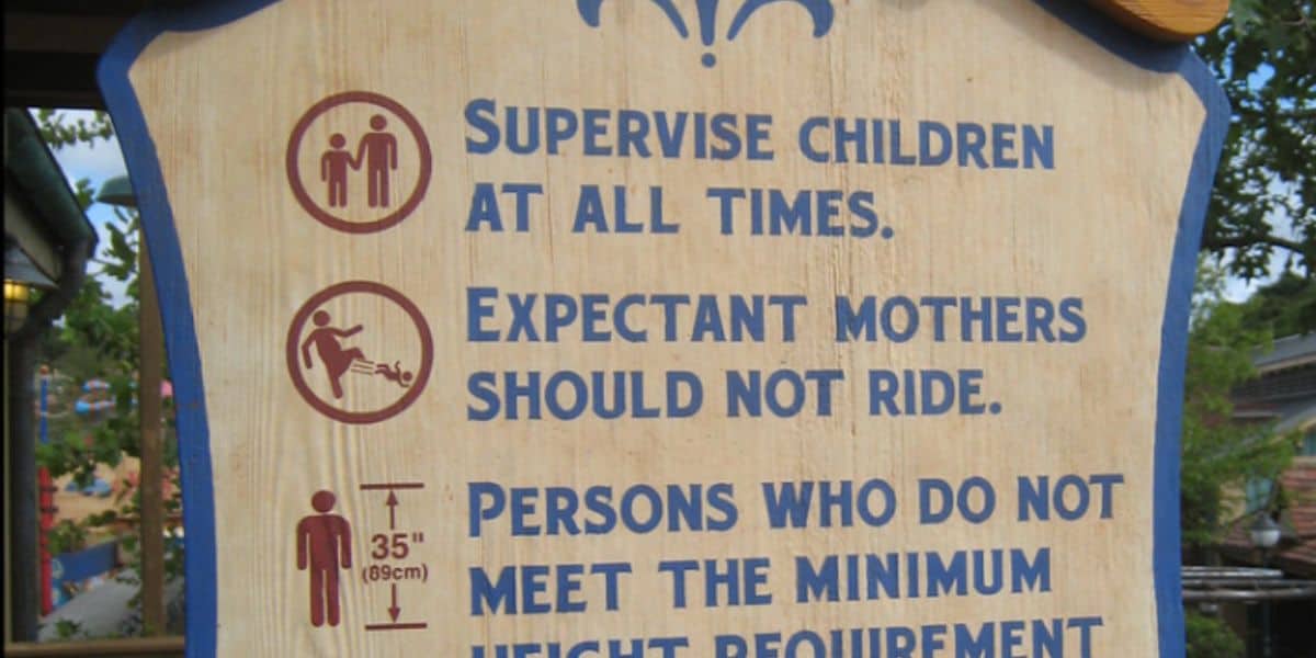 A sign at a Disney Park warning pregnant people not to ride an attraction.