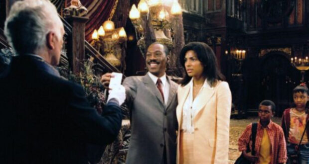 A man in a suit smiles and presents a card to an older man in a dark, ornate room, while a woman and two children stand beside him, looking serious. The setting is dimly lit with elaborate decor and chandeliers.