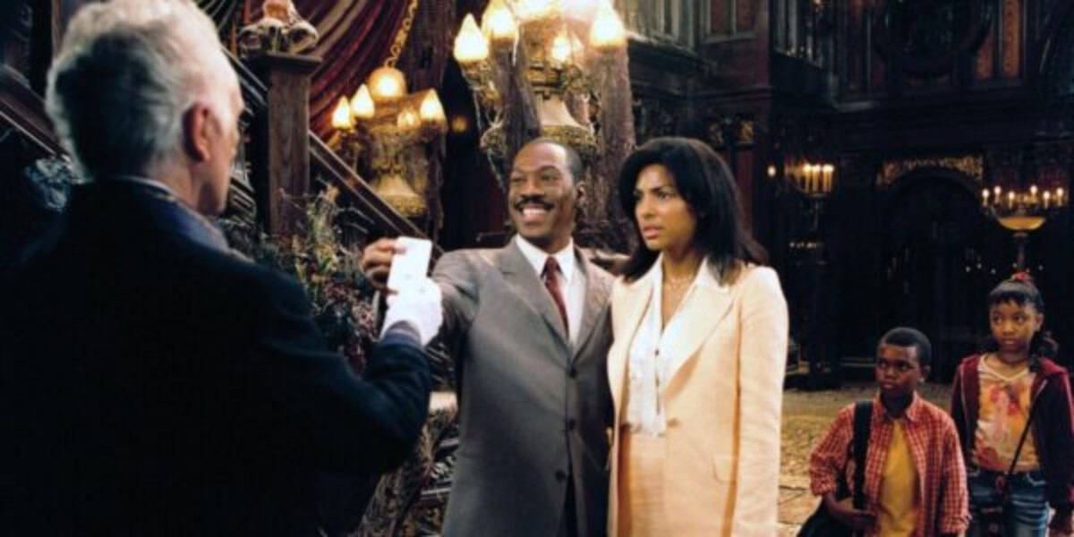 A man in a suit smiles and presents a card to an older man in a dark, ornate room, while a woman and two children stand beside him, looking serious. The setting is dimly lit with elaborate decor and chandeliers.
