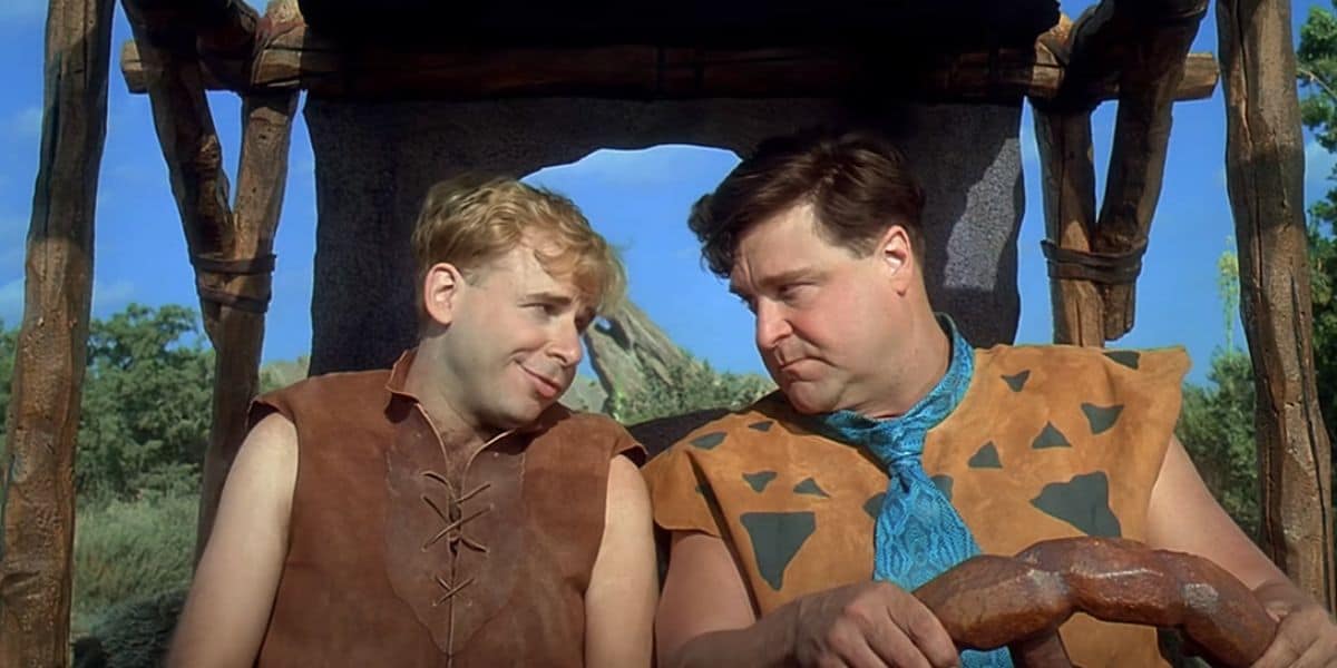 L to R: Rick Moranis as Barney Rubble and John Goodman as Fred Flintstone driving to work in 'The Flintstones'