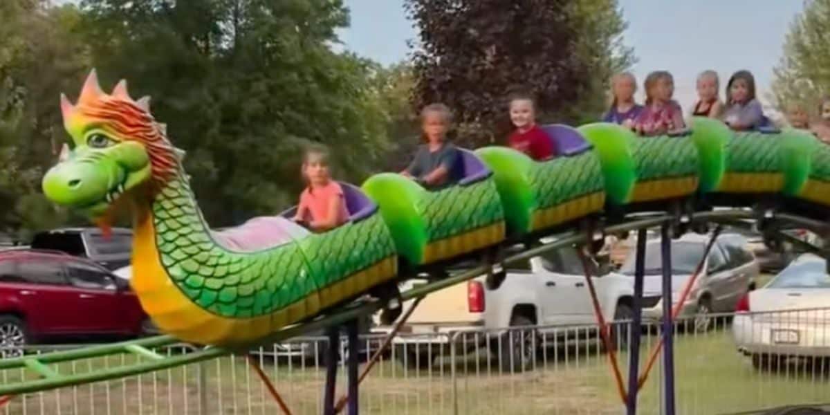 Children on a dragon roller coaster after an accident that caused the wheels to fall off.