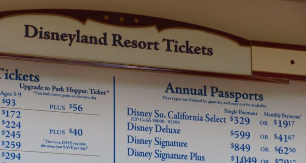 A sign at Disneyland Resort displays prices for theme park tickets.