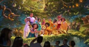 A colorful group of animated characters pose with animals in a lush, magical jungle. In the foreground, silhouettes of people watch, suggesting an immersive theme park attraction. Sparkling lights and glowing plants fill the scene.