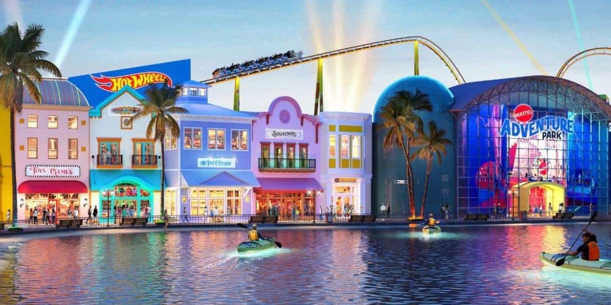 Hot Wheels roller coaster, vibrant shops, and guests enjoying boat rides on the scenic waterway at sunset in Universal Studios.