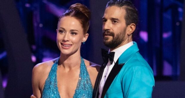 Whitney Leavitt and partner dazzle onstage in blue formalwear, radiating Disney Princess magic fit for a Dancing with the Stars show.