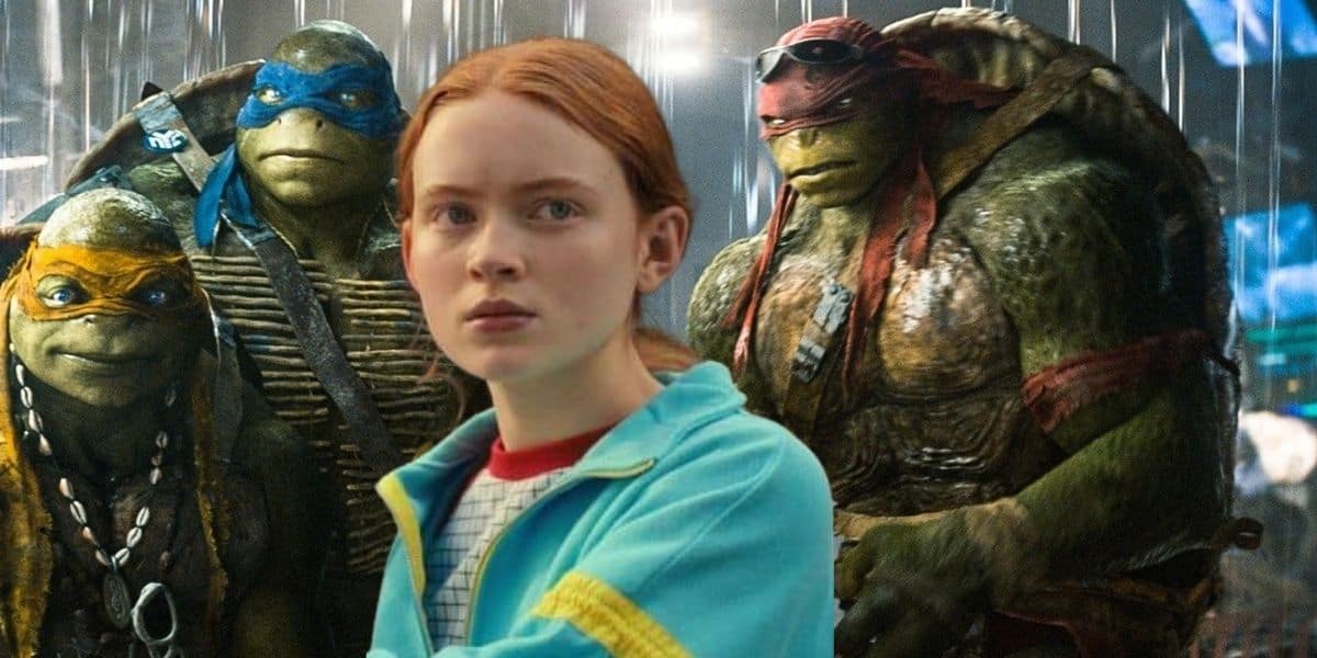 Sadie Sink as April O’Neil poses with the Teenage Mutant Ninja Turtles in moody lighting, teasing the Ninja Turtles Reboot.