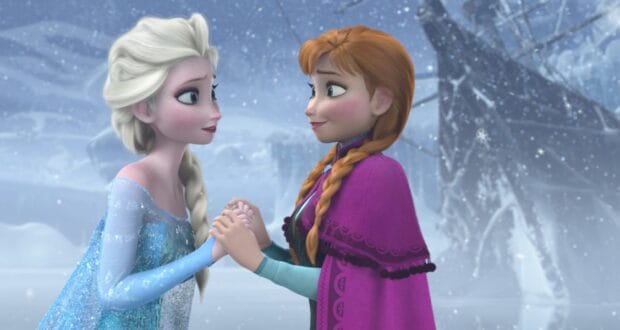 Anna and Elsa clasp hands in the snow
