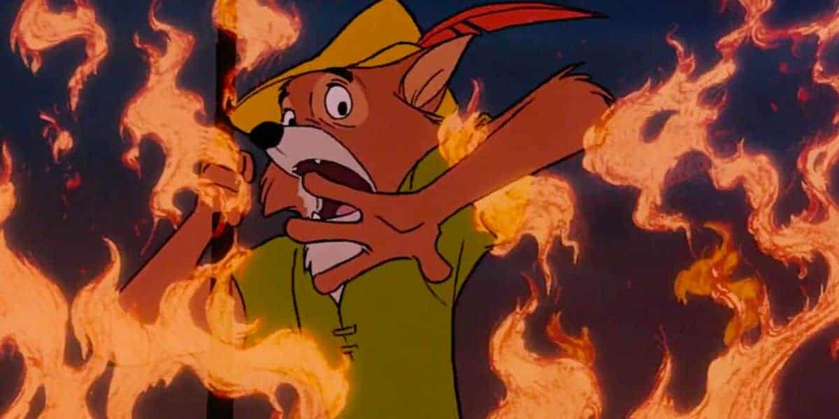 Robin Hood, in his signature green shirt and hat, appears startled as flames blaze around him during the parade spectacle.