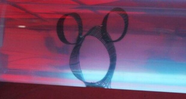 A classic Hidden Mickey silhouette glows under red and blue lights, capturing Disney World’s secret-spotting tradition.