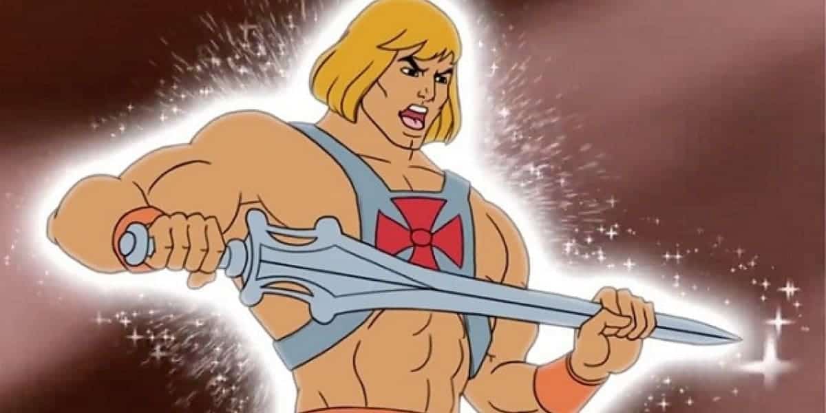 He-Man triumphantly lifts his glowing Power Sword under dazzling lights and sparkles, ready for adventure at Universal Studios.