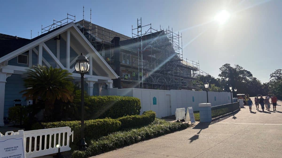 Beach Club Resort at Disney World under construction with scaffolding and fences as guests stroll by during 2027 refurbishment.