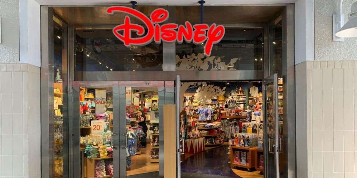 Disney Pop Up Store entrance with iconic red Disney logo, glass doors displaying merch; fans buzzing about its possible comeback.