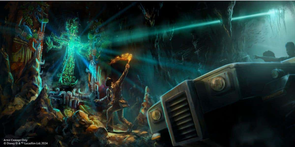 An adventurer with a torch encounters the glowing temple idol in an Indiana Jones ride scene as a jeep races toward them.