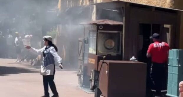 A Disneyland Paris cast member directs guests away from a popcorn cart on fire in Frontierland