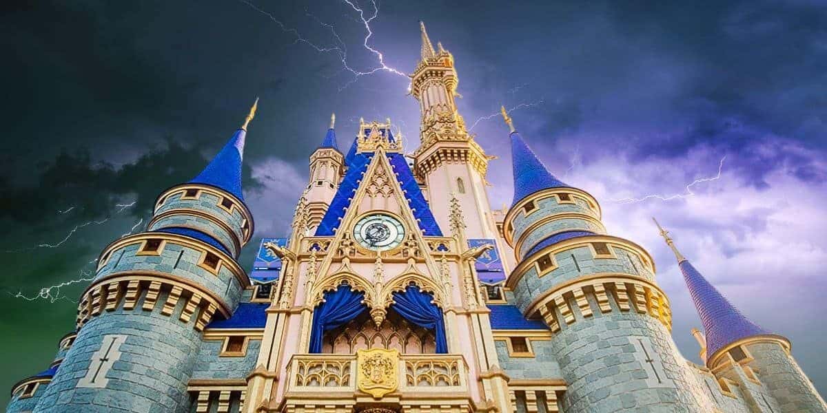 A dramatic image of Cinderella's castle at Disney World with dark, stormy skies and multiple lightning strikes illuminating the background. Disney World power outage