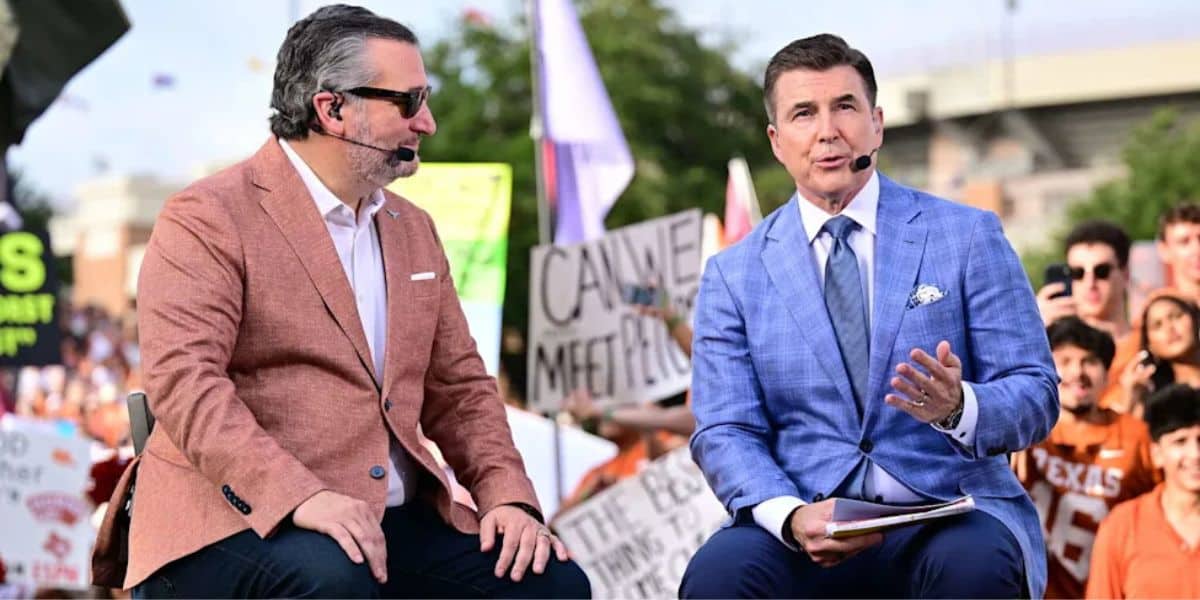 Two sports announcers in sharp suits engage in lively conversation on a broadcast stage, with an enthusiastic audience waving colorful signs and cheering wildly behind them, creating a vibrant atmosphere reminiscent of a high-energy live show you’d find at Universal Studios or ESPN Zone.