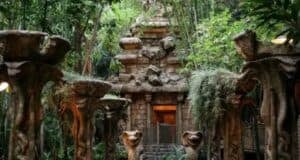 Indiana Jones Adventure temple nestled in thick Disneyland jungle, with iconic statues and flourishing greenery flanking the path—bringing epic adventure vibes even when the attraction is temporarily closed.
