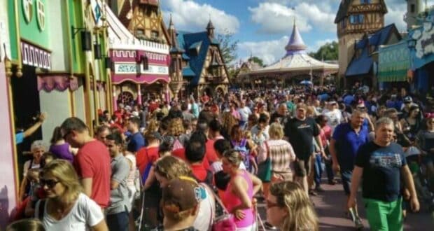 Guests walking through a crowded Fantasyland at Magic Kingdom.