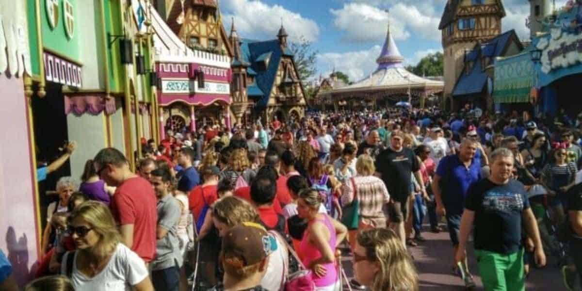 Guests walking through a crowded Fantasyland at Magic Kingdom.