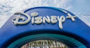 Disney+ branded inflatable archway at a Disney theme park, highlighting the streaming service’s collection of franchises.