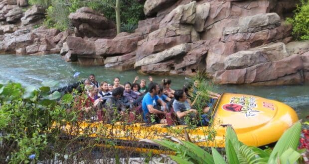 Guests on the Jurassic Park River Adventure at Universal Studios.