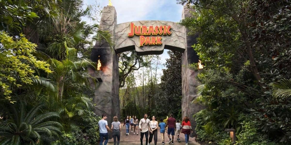 Guests pass through the Jurassic Park gates at Universal Orlando.