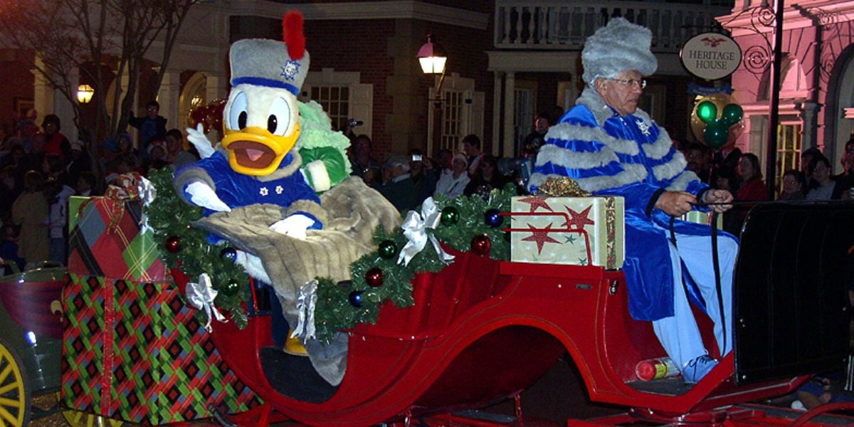 Donald Duck in a horse-drawn carriage during the Magic Kingdom holiday parade at Disney World.