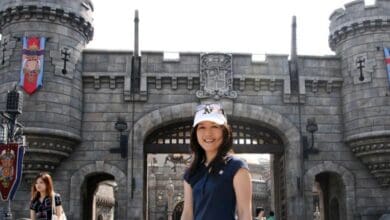 A woman posing in front of the Hogwarts castle entrance at The Wizarding World of Harry Potter, captured during a denied insurance claim.