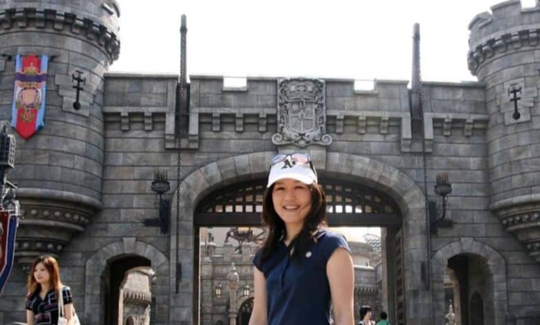 A woman posing in front of the Hogwarts castle entrance at The Wizarding World of Harry Potter, captured during a denied insurance claim.