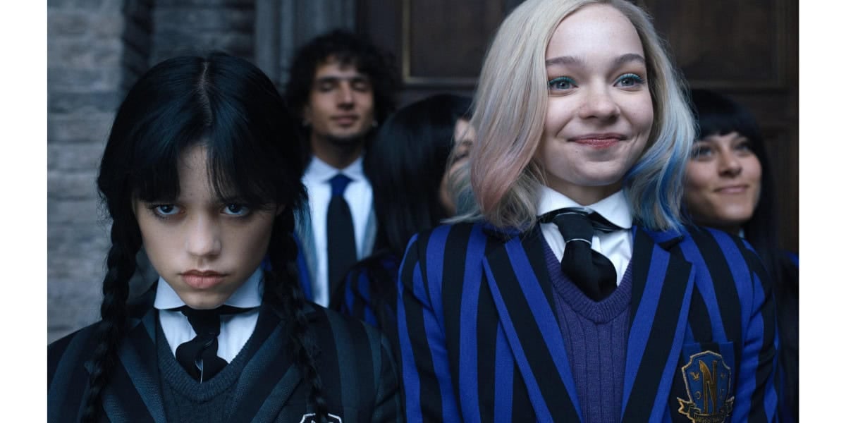 Wednesday Addams and Enid Sinclair in their Nevermore Academy uniforms from Wednesday.