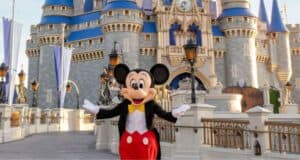 Mickey Mouse at Cinderella Castle in Disney World.