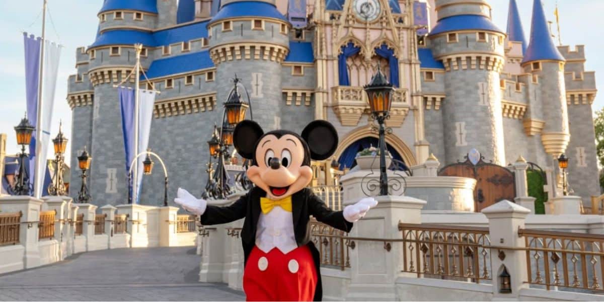 Mickey Mouse at Cinderella Castle in Disney World.