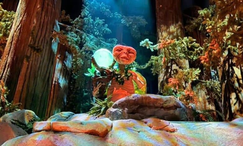 E.T. holds a glowing orb on the E.T. Adventure at Universal Orlando.