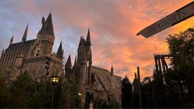 Hogwarts Castle at The Wizarding World of Harry Potter silhouetted against a sunset sky.