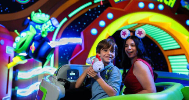 Guests on Buzz Lightyear’s Space Ranger Spin at Magic Kingdom.