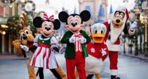 Pluto, Minnie, Mickey, Donald, and Goofy in holiday outfits at Mickey’s Very Merry Christmas Party at Magic Kingdom, Disney World.