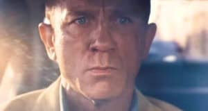 James Bond with a serious expression behind the wheel in the new James Bond film.