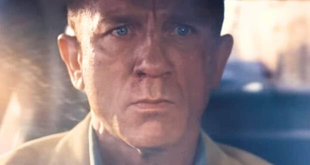 James Bond with a serious expression behind the wheel in the new James Bond film.