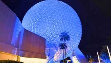 Spaceship Earth at EPCOT glowing at night.