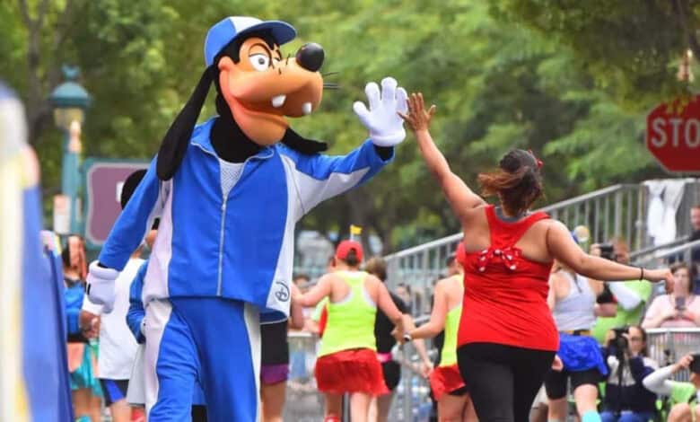 Goofy high-fives a runner during the runDisney Wine & Dine Half Marathon at Walt Disney World.