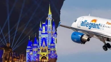 An Allegiant airplane flying over Cinderella Castle at Disney World.