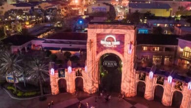 Universal Studios Florida entrance archway illuminated for Halloween Horror Nights, seen from above.