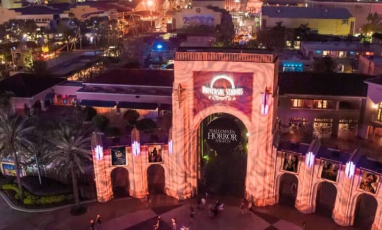 Universal Studios Florida entrance archway illuminated for Halloween Horror Nights, seen from above.