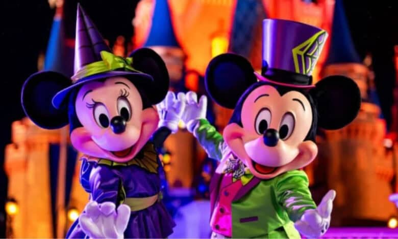 Mickey and Minnie Mouse in Halloween costumes at Disney World.