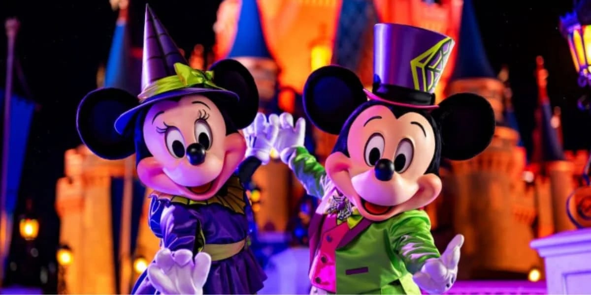 Mickey and Minnie Mouse in Halloween costumes at Disney World.